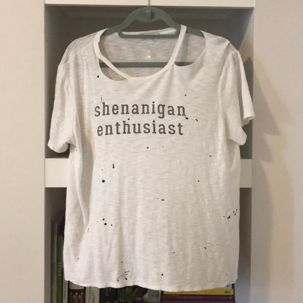 Worn and purposefully tattered shirt